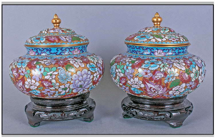 Pair Of Chinese Lidded Cloisonne Vases, highlighted in gilt work, depicting famile rose coloured