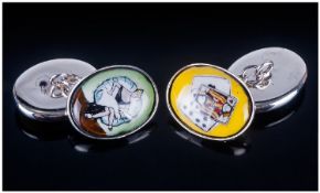 Gents Pair Of Novelty Cufflinks. Oval enamelled fronts, one depicting champagne bottle and glasses,