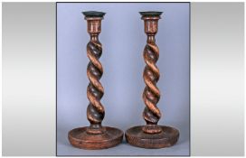A Pair of Barley Twist Oak 1920`s Candlesticks, with brass candle grips. Height 14 Inches.