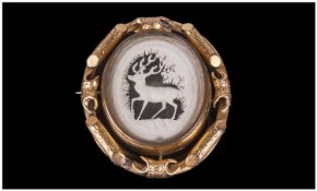 19th Century Swivel Brooch, with glazed front and back. The front depicting a carved stag, engraved
