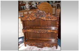 A French Provencial Carved Oak Wall Bracket Shelf in traditional Normandy style. The shaped top