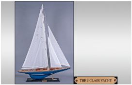 Collectors Model Yacht. Raised on black rectangular wooden plinth, label to plinth reads ``The J-