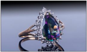 Ladies 9ct Gold Dress Ring, set with a large pear shaped central mystic topaz surrounded by 20