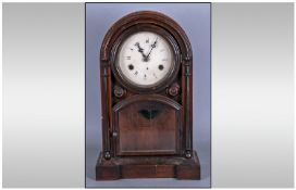 An American Rose Wood Mantle Clock, with a round painted dial, with lower glaze door. Height 16