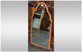 Mirror with Tapering top design. Encased in a wood like  frame. 29 inches high, 15 inches at widest
