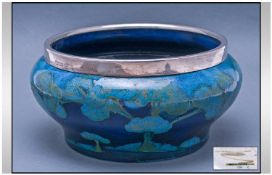Moorcroft Moonlit Blue Pattern Bowl with silver plated rim, the turquoise blue and green trees on a