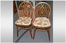 Pair Of Beech Stinted Wheel Stick Back Chairs with loose cottage decorated seat cushions.