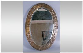 Brass Framed Art Nouveau Oval Mirror with bevelled Glass. Embossed with ivy leaves. 34 inches high,