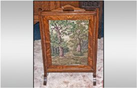 1930`s Oak Firescreen with an embroidered picture of a forest scene. 26x18``