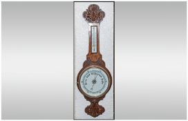 Edwardian Carved Oak Banjo Shaped Barometer, including thermometer and barometer. 33`` in height.