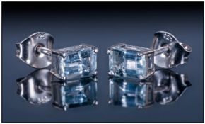 Aquamarine Octagon Cut Stud Earrings, each earring having a solitaire Brazilian aquamarine in a