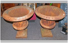 Large Pair Of Cast Iron Garden Urns of Campagna shape with a rubbed fluted body, terminating on a