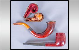 Meerschaum Cheroot Holder and Two Wood Pipes, the meerschaum carved as an eagle`s talons clutching