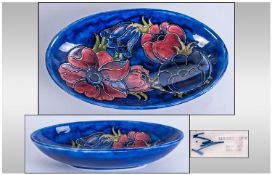 Moorcroft Boat Shaped Bowl `Clematis` Pattern on blue ground. 9`` in diameter.