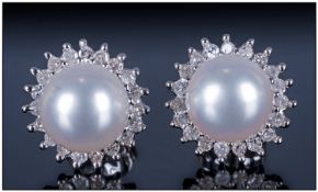 9ct White Gold Diamond & Pearl Earrings, Central pearl surrounded by 20 diamonds.