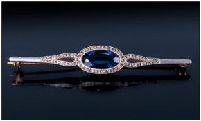 Early 20th Century High Carat Gold Bar Brooch set with a central deep blue oval Sapphire, (