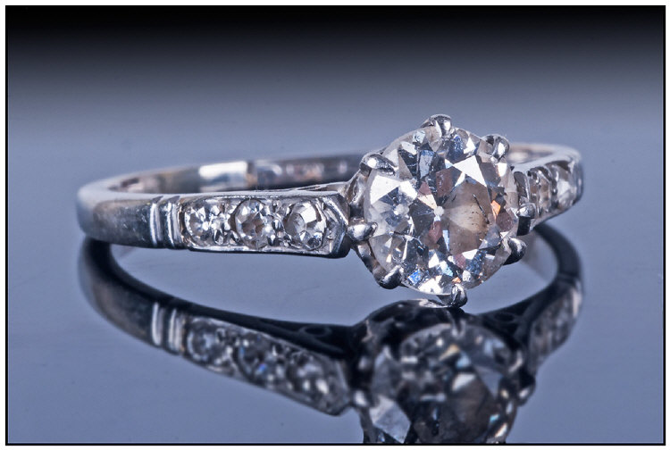 A Platinum Set Single Stone Diamond Ring with six small diamonds to shoulders. est diamond weight