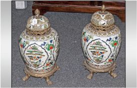 A Pair Of 20th Century Chinese Decorated Porcelain Jars in the Famille Verte decoration. Ormolu