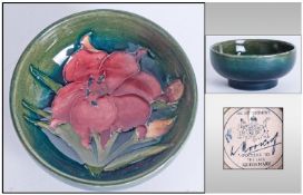Moorcroft Small Footed Bowl, orchids pattern on green ground. Label to base reads ``Potters To The