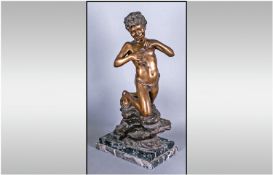 An Italian Bronze OF A Neopolitan Fisher Boy holding a fish in one hand & kneeling on a bronze