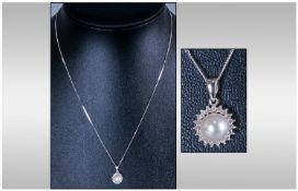 9ct White Gold Diamond & Pearl Pendant. Central pearl surrounded by 19 diamonds.
