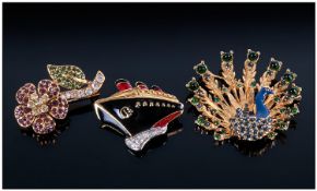 Three Ciro Brooches, one a peacock with open tail feathers, studded with blue and green crystals