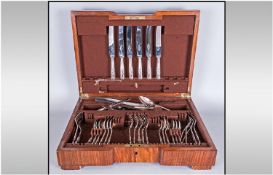 A Part Plated Canteen Of Cutlery, EPNS, Queen Pattern, housed in a fitted walnut case.