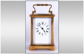 English Early 20th Century Brass Carriage Clock with visible escapement & glass panels. White