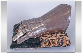 Medieval Interest. Medieval iron articulated gauntlet. Riveted with part leather lining. Possibly
