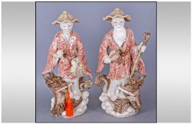 Pair Of Oriental Figures Of Two Men, one of a sage & one holding a basket. Both with a dragon