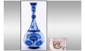 WITHDRAWN    Florian Onion Shape Bottle Vase, Blue Cornflower pattern, showing 3 panels of
