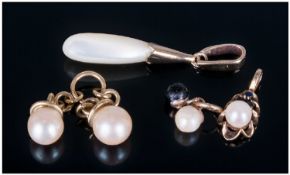 Collection Of Four Gold Pearl Set Pendants.