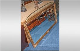 A Large Bevelled Edge Mirror with a silver gilt frame. 52x30``