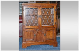 Olde Charme Double Leaded Door Front Oak Cabinet with Cupboards below and a Carved Centre on