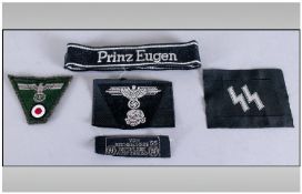 Military Interest Comprising German WW2 Army cap badge, W/SS Prime Eusen Cuff Title, Allesmeiness