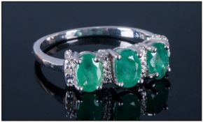 Emerald Three Stone Ring with diamond accents, three oval cut Sagota emeralds, of good colour,