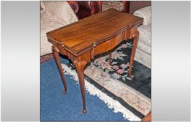 An Edwardian Mahogany Lift Flap Tea Table In The Queen Anne Style. one shaped cabriole legs, shaped