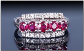 18ct White Gold Cluster Ring Set With A Central Row Of Five Rubies, Between two Rows Of Round Cut
