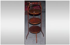 An Edwardian Mahogany Three Tier Inlaid Cake Stand with Carrying Handle. Size 36 Inches High.