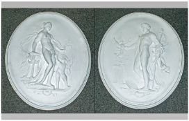 Pair of Plaster Oval Wall Plaques, In the classical style, depicting a man and a woman.