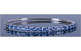 Tanzanite Hinged Bangle, the oval cut stones in a single horizontal row across the front, 5.5cts