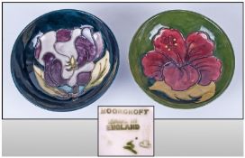 Moorcroft Small Footed Bowls, 2 in total. 1. Hibiscus Pattern, on green ground. Label to base reads