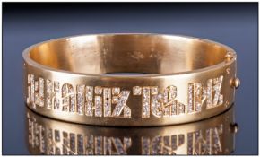 Unmarked Yellow Metal Hinged Bangle, the front with an unusual Diamond set script. Unmarked tests