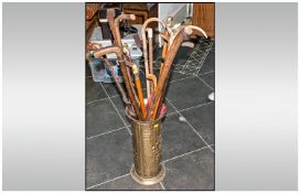 Brass Embossed Umbrealla Stand with 16 various walking sticks, seven with horn handles.
