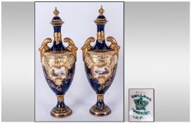 Coalport 19th Century Pair Of Two Handle Lidded Vases, painted scenic views to central panels with