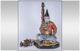 Oriental Figural Table Lamp depicting Japanese figure sat on a tiger print rug. 18`` in height