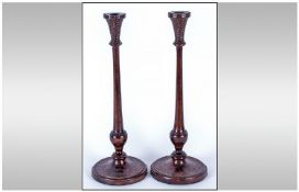 Pair of Tall Elegant Pokerwork Candlesticks, the circular bases bordered with a circle of subtle