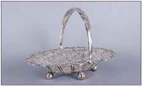 An Edwardian Silver Oval Shaped Basket embossed & pierced with a swirled design. A hinged plain