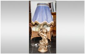 Floor / Large Table Lamp in the Cherub style. Gilt in colour together with a Large Purple Shade,