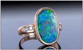 18ct Gold Single Stone Oval Shaped Black Opal Set Ring with Diamond shoulders. The black opal is